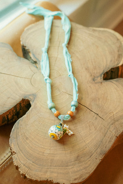 Italian porcelain pendant w/ pearls + beaded blue