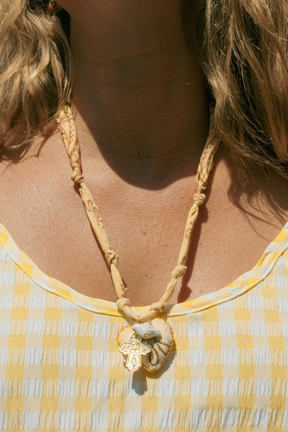 Hand beaded bandana heart (handmade in Paris) w/ layered vintage cross and dove + butter yellow